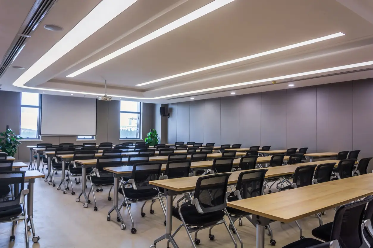 Bright classroom-style training room with rows of tables and chairs
